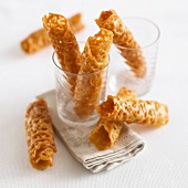 Brandy Snaps in a glass and next to it