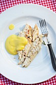 Grilled cod fillets with cheese sauce