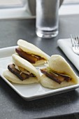 Braised Pork Belly in clam shell bun with scallions