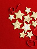 Star cookies for Christmas in front of a red background