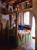 Comfortable reading area with built-in bookcase next to window in renovated, Mediterranean country house