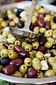 Pickled green and black olives with garlic and herbs