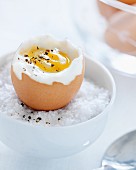 Soft boiled egg in a bowl with salt
