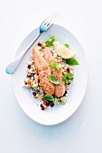 Salmon on couscous with pomegranate seeds