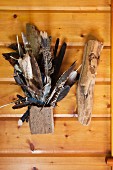 Various local bird feathers are used as decor in an Adirondacks cabin