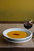A bowl of carrot soup with Harissa