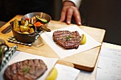 Beef steak with potatoes and vegetables in a restaurant