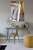 Small desk, vintage chair and artistic photo on wall
