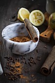 Chai spice mixture with cinnamon and cloves in a mortar