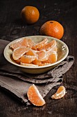 Peeled clementines in a porcelain bowl