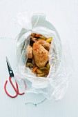 Spring chicken with vegetables in a roasting bag