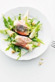 Goat's cheese saltimbocca on rocket salad with pear and walnuts