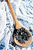 Black sea salt on a wooden spoon