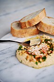 Hummus Spread with bread on marble plate