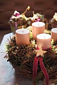 Rustic Advent wreath with four candles in wicker basket