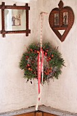 Wreath of pine branches and berries between vintage pictures