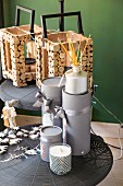 Festive arrangement of candles, presents wrapped in grey and wooden lanterns