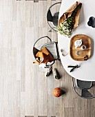 Retro dining table & metal chairs in interior with decorative, pale grey, wood-effect tiled floor