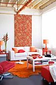Living room - white coffee table on orange rug and grey lino floor, white sofa in front of tall floral fabric panel on wall