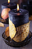 Candles decorated with painted autumn leaves