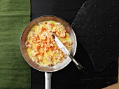 Omelette with prawns in a frying pan