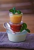 Quark, strawberry compote and pear compote in stacked jars