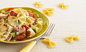 Pasta salad with avocado, tomatoes, ham and chicken