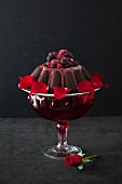 Chocolate cake with berries and rose on a black background
