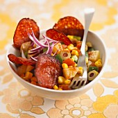 Vegetable stir-fry with slices of fried chorizo