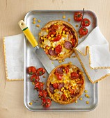 Mini tarts with salami, sweetcorn and tomatoes (view from above)