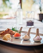 Three different amuse-bouches on a serving plate