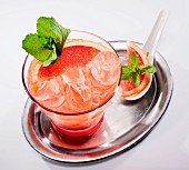 Grapefruit cocktail with fresh mint on a silver tray