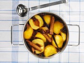 Stewed peaches with cinnamon sticks, star anise and vanilla pods
