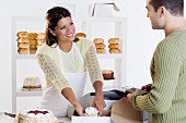 Woman at bakery helping customer
