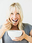 Young woman eating muesli