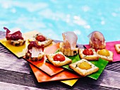 Assorted tartines on the edge of a swimming pool