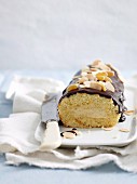Swiss roll with chocolate glaze and flaked almonds
