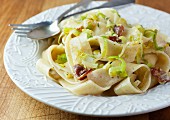 Ribbon pasta with bacon and leek