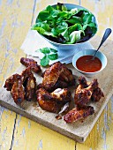 Spicy chicken wings with chipotle, chilli sauce and lettuce