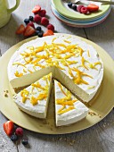 Cheesecake with lemon zest, partly sliced