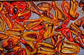 Baked red and yellow peppers on a baking tray