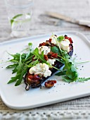 Baked aubergine topped with sundried tomatoes, mozzarella and rocket