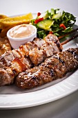 Mixed kebabs with salad and dip (Greece)