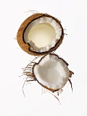 Coconut cracked in half with shell and husk