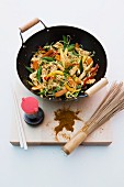 Strips of turkey stir-fried in a wok with vegetables and noodles