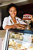 African American bakery owner standing in shop