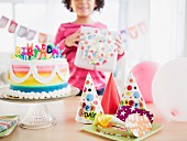 African American girl holding gift at birthday party