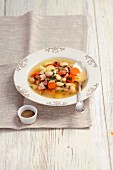 Vegetable soup with sausage, bacon and white beans