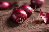 Red onions on brown material