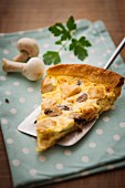 A slice of mushroom quiche with parsley
